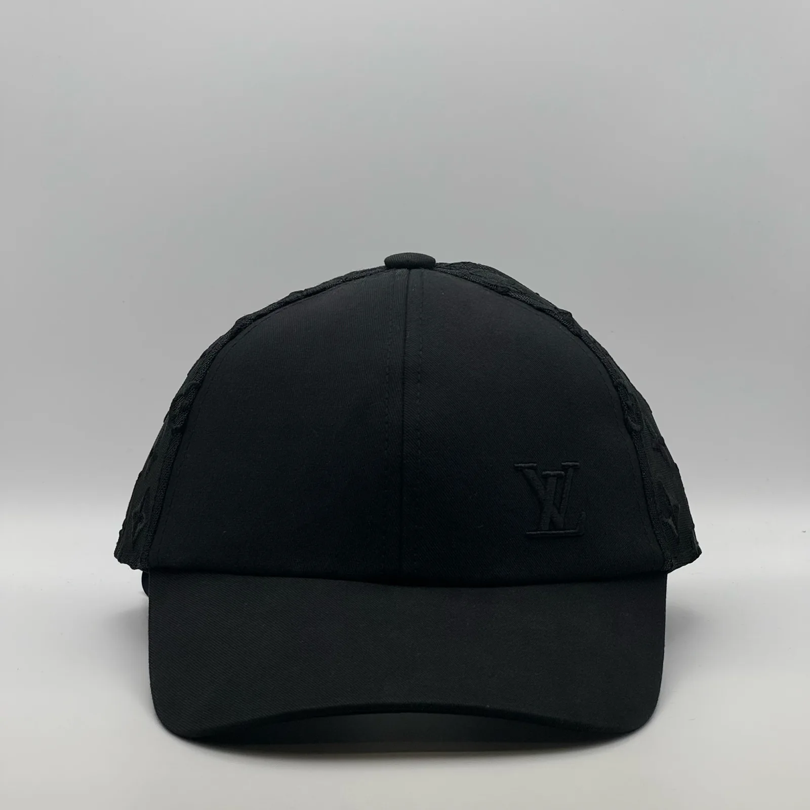Black Louis Vuitton Monogram Mesh cap, front view showing the LV logo.