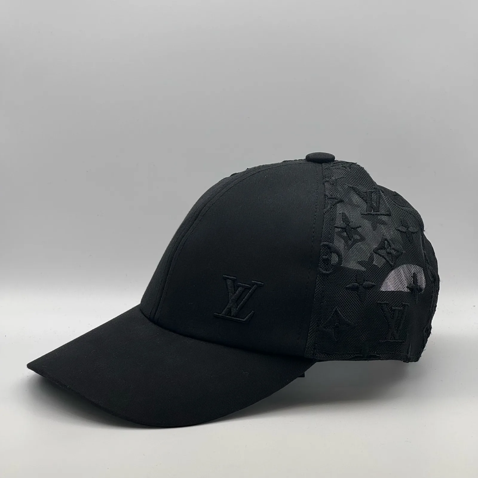 Black monogram mesh cap, opposite side view.